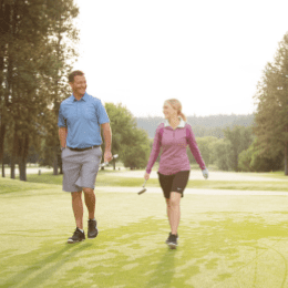 man and woman golfing